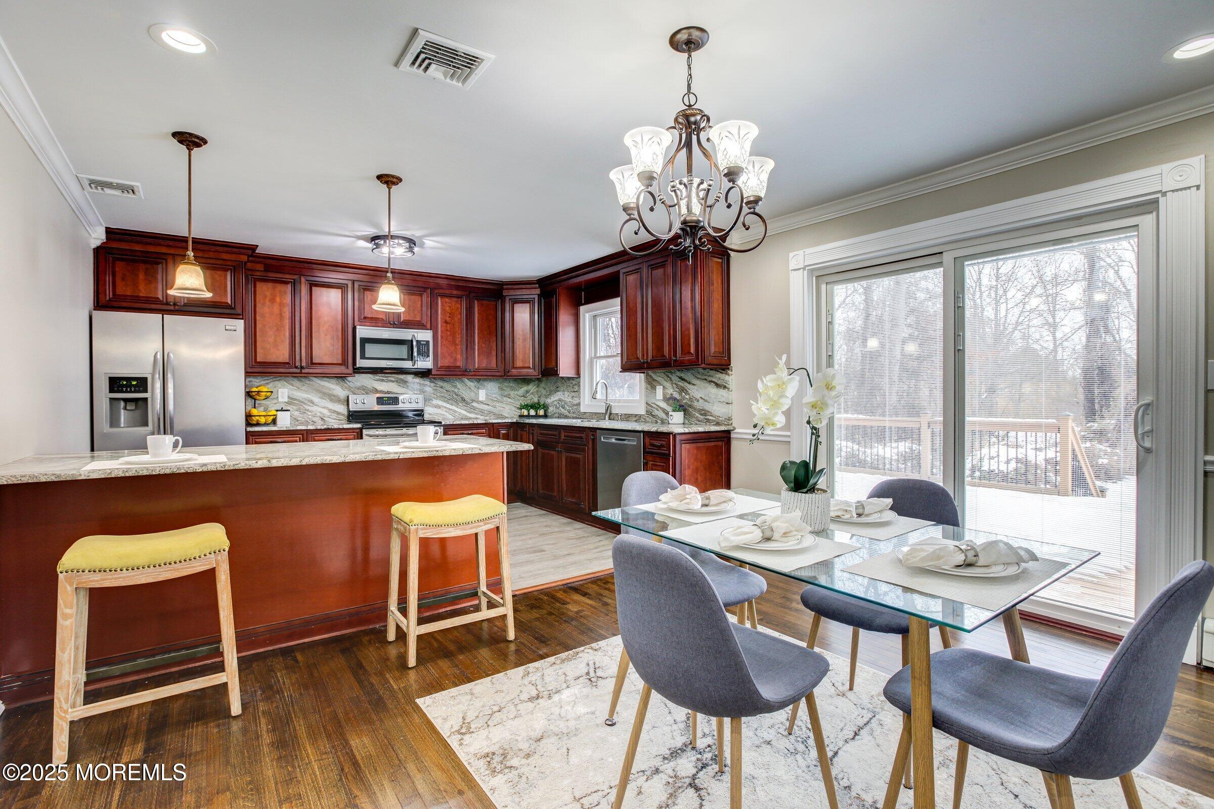 119 E Road Belford, NJ 07718 - Photo 5 of 21 a dining room filled chandelier and wooden furniture