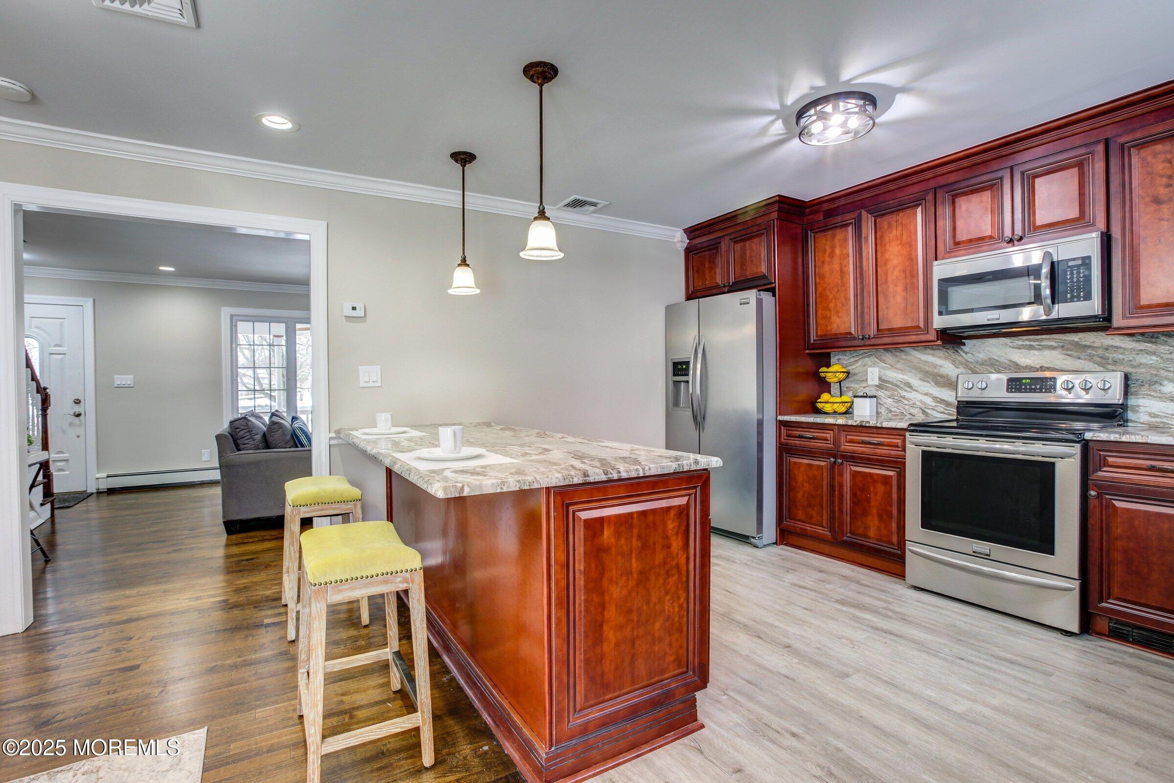119 E Road Belford, NJ 07718 - Photo 6 of 21 a kitchen with a refrigerator a stove top oven a sink dishwasher and wooden cabinets