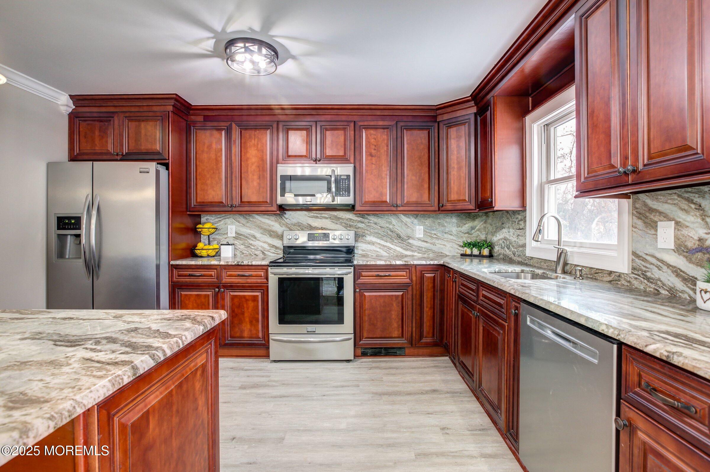 119 E Road Belford, NJ 07718 - Photo 8 of 21 a kitchen with stainless steel appliances granite countertop a stove a sink dishwasher and a refrigerator