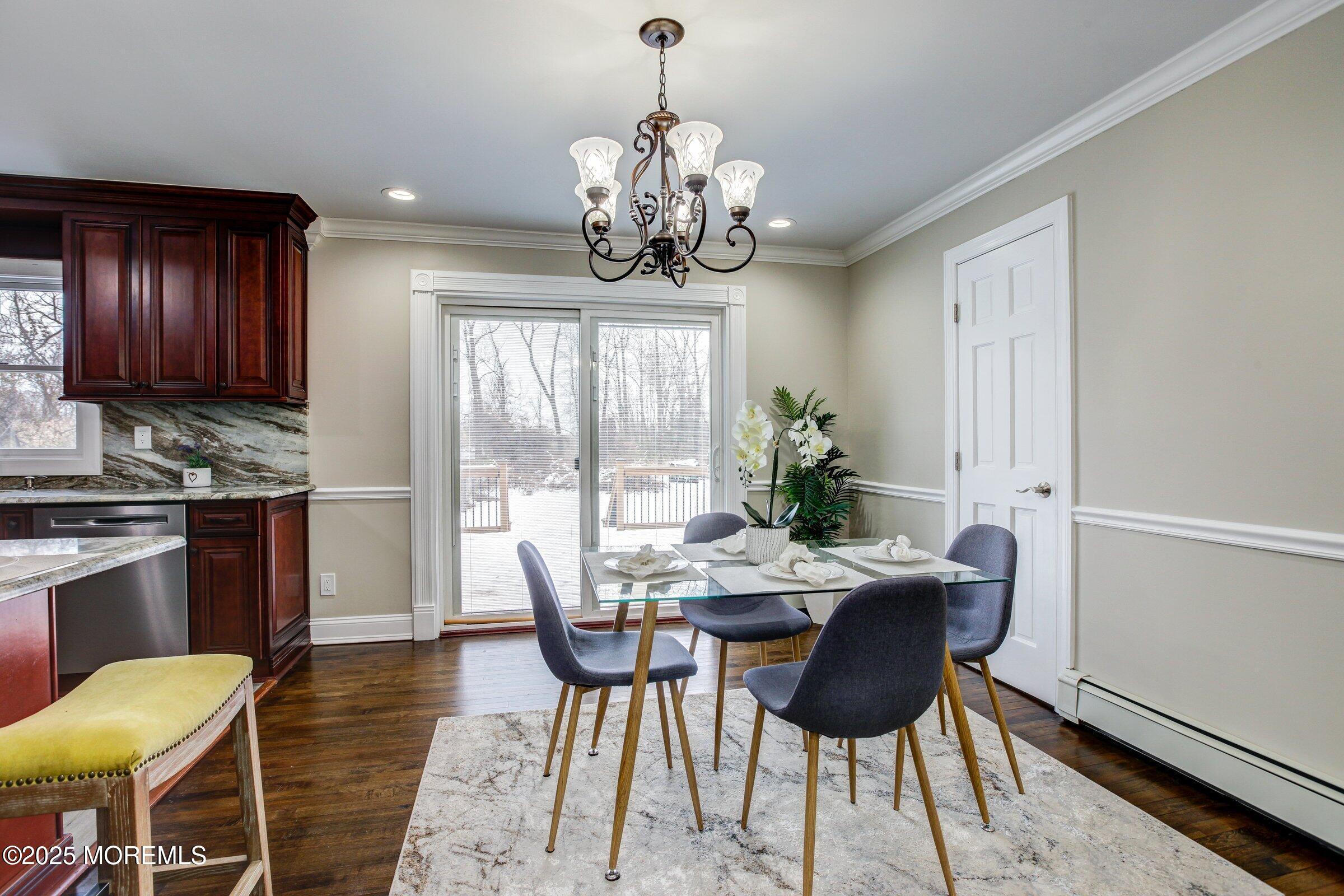 119 E Road Belford, NJ 07718 - Photo 9 of 21 a dining room with furniture a chandelier and wooden floor