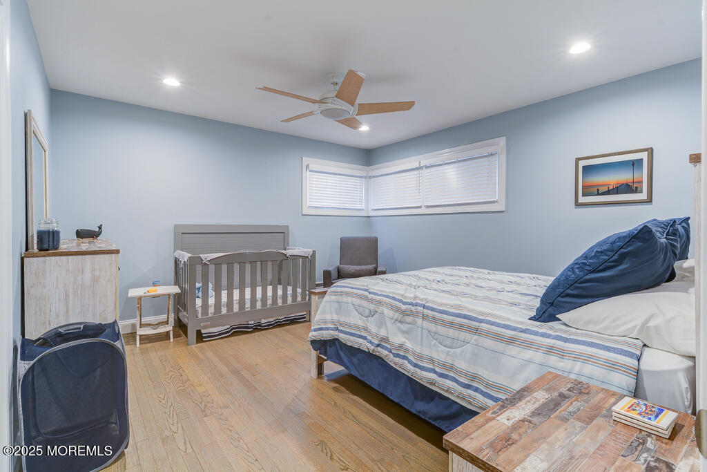 10 E Street Seaside Park, NJ 08752 - Photo 11 of 26 a bedroom with a bed and a chair