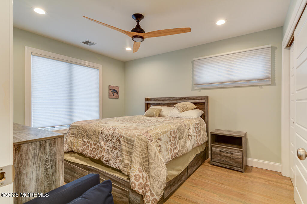 10 E Street Seaside Park, NJ 08752 - Photo 14 of 26 a bedroom with a bed and a ceiling fan