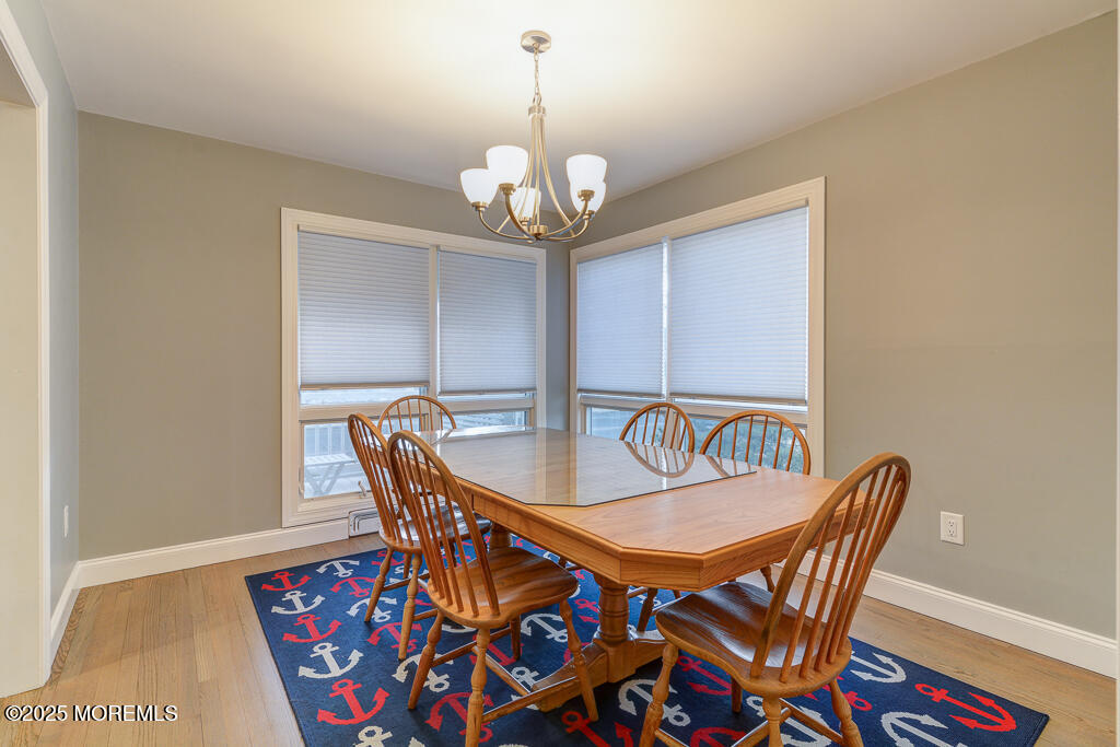 10 E Street Seaside Park, NJ 08752 - Photo 4 of 26 a dining room with furniture a rug and a chandelier
