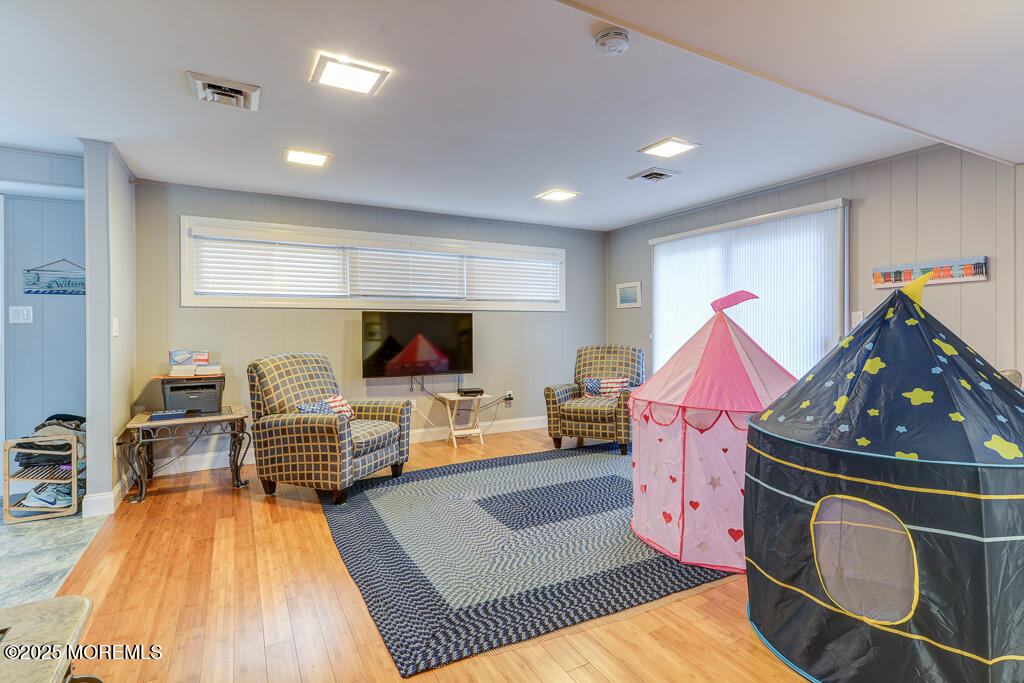 10 E Street Seaside Park, NJ 08752 - Photo 6 of 26 a living room with furniture and a flat screen tv