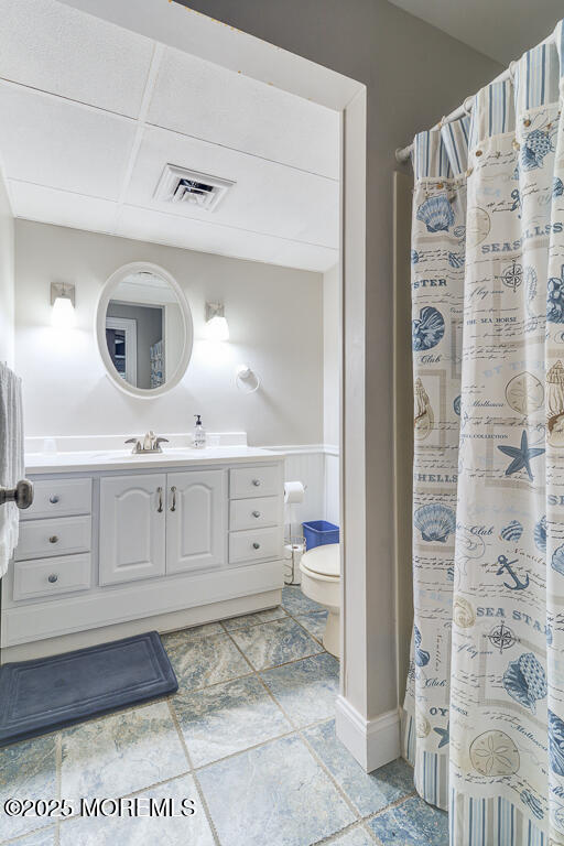 10 E Street Seaside Park, NJ 08752 - Photo 8 of 26 a bathroom with a double vanity sink a toilet and shower