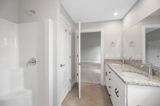 a bathroom with a granite countertop sink mirror and double