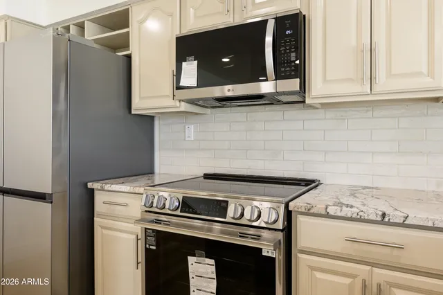 a stove top oven sitting inside of a kitchen