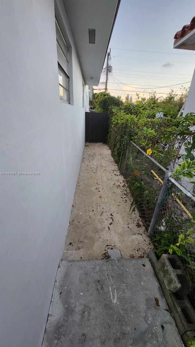 3312 Southwest 24th Terrace Miami, FL 33145 - Photo 12 of 13 a view of a dry yard with wooden fence