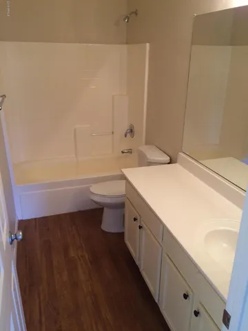 a bathroom with a sink a toilet and bathtub