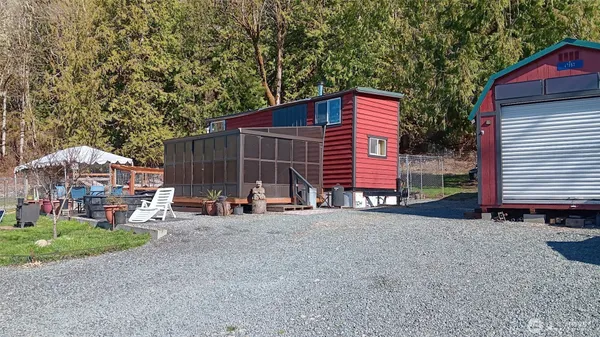 a view of a house with backyard and sitting area