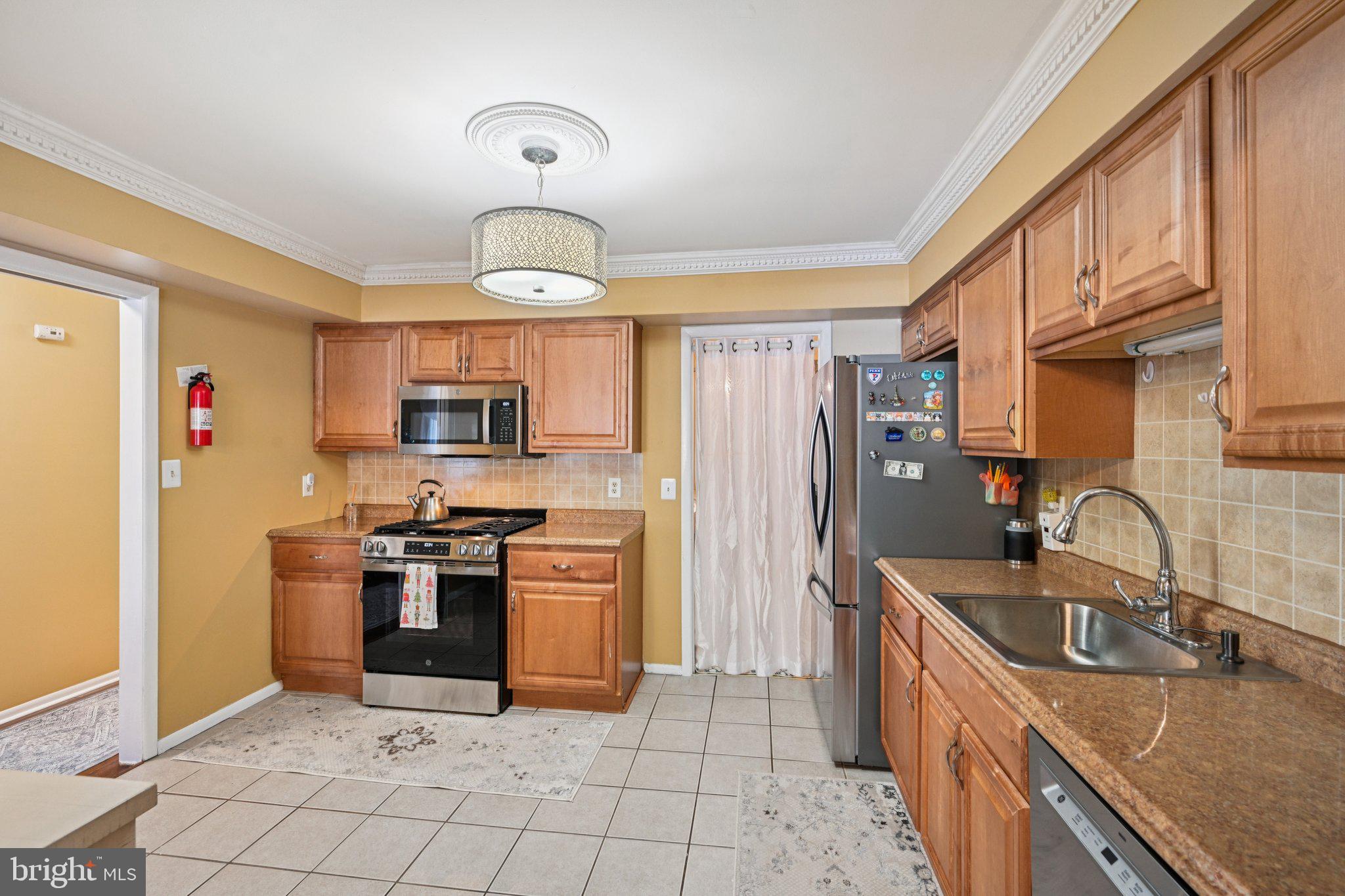 18 Jacob Court Trenton, NJ 08628 - Photo 16 of 43 a kitchen with stainless steel appliances granite countertop a sink stove and refrigerator