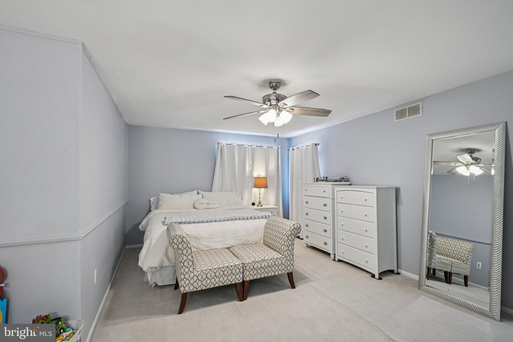 18 Jacob Court Trenton, NJ 08628 - Photo 30 of 43 a spacious bedroom with a bed and a chandelier