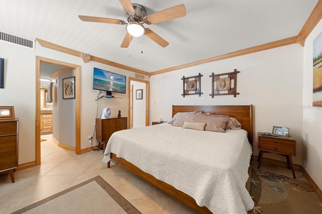 506 Gulf Boulevard, Unit 201 Indian Rocks Beach, FL 33785 - Photo 14 of 30 a bedroom with a bed and a chandelier