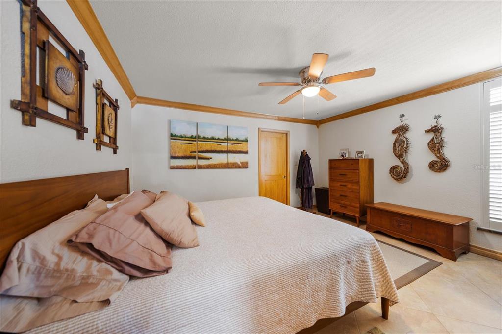 506 Gulf Boulevard, Unit 201 Indian Rocks Beach, FL 33785 - Photo 15 of 30 a bedroom with a large bed and a chandelier