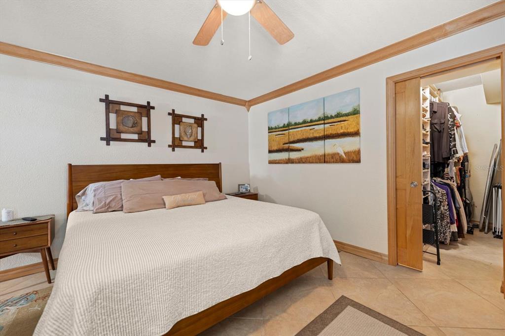 506 Gulf Boulevard, Unit 201 Indian Rocks Beach, FL 33785 - Photo 16 of 30 a bedroom with a bed and a chandelier