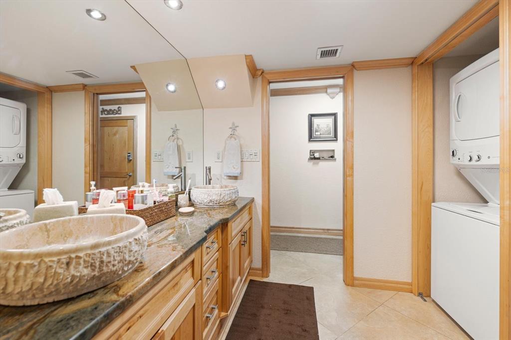 506 Gulf Boulevard, Unit 201 Indian Rocks Beach, FL 33785 - Photo 20 of 30 a spacious bathroom with sinks mirror and a bathtub