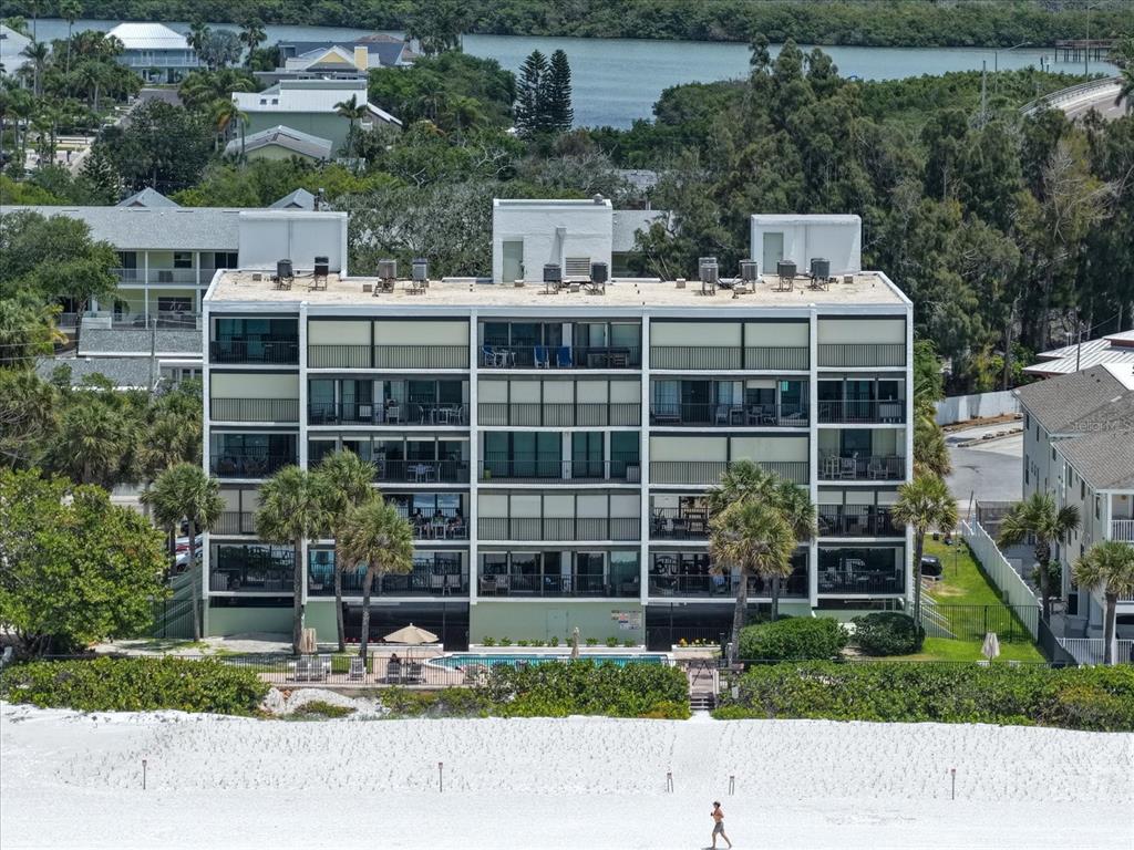 506 Gulf Boulevard, Unit 201 Indian Rocks Beach, FL 33785 - Photo 2 of 30 a front view of a house with a garden