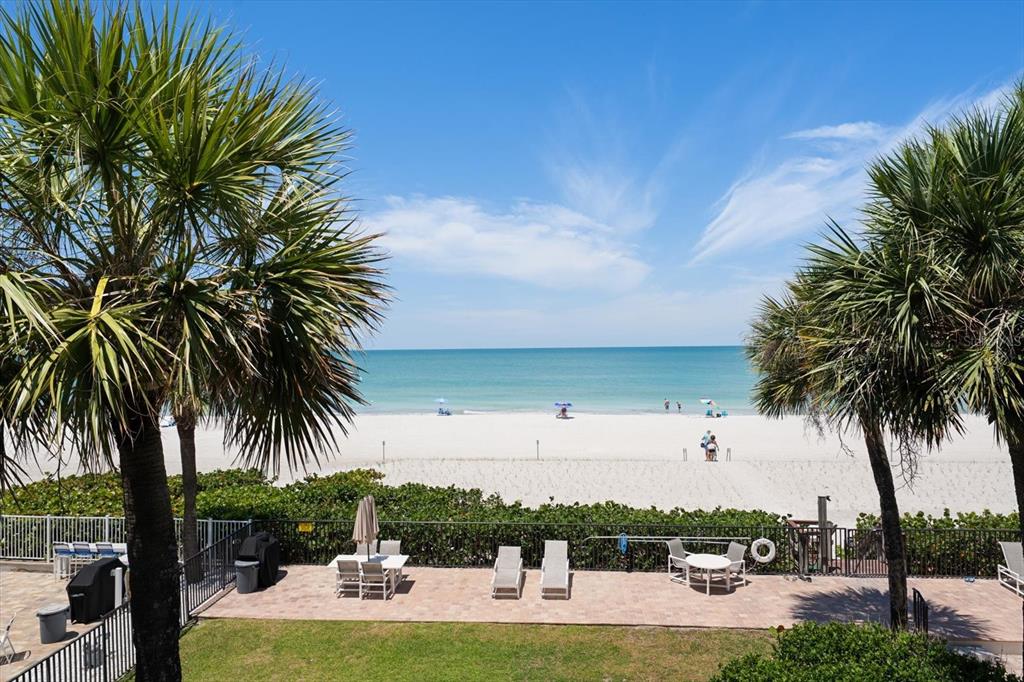 506 Gulf Boulevard, Unit 201 Indian Rocks Beach, FL 33785 - Photo 22 of 30 a view of a swimming pool with a table and chairs