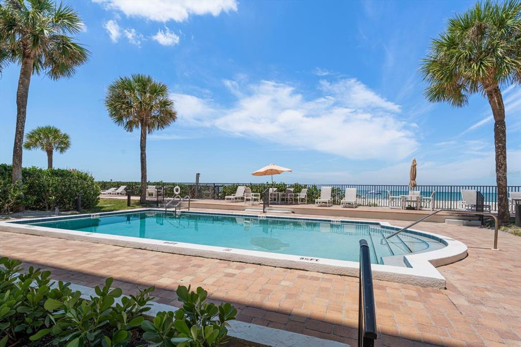 506 Gulf Boulevard, Unit 201 Indian Rocks Beach, FL 33785 - Photo 28 of 30 a view of a swimming pool with a table and chairs