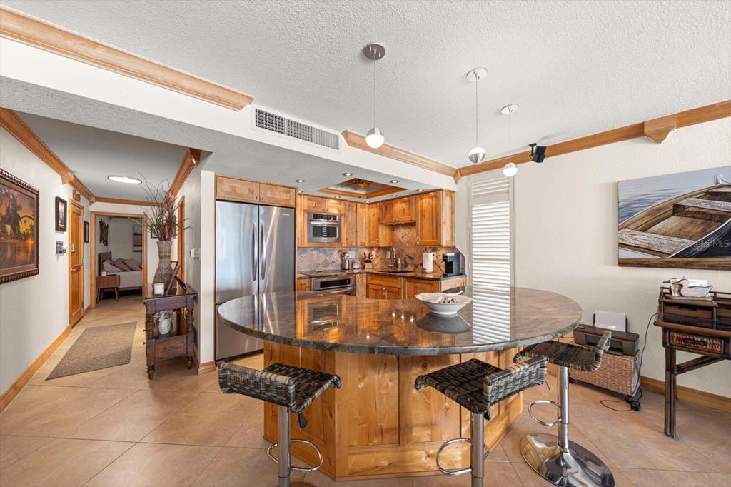 506 Gulf Boulevard, Unit 201 Indian Rocks Beach, FL 33785 - Photo 4 of 30 a dining room with furniture and a chandelier