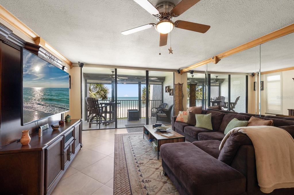506 Gulf Boulevard, Unit 201 Indian Rocks Beach, FL 33785 - Photo 9 of 30 a living room with furniture and a flat screen tv