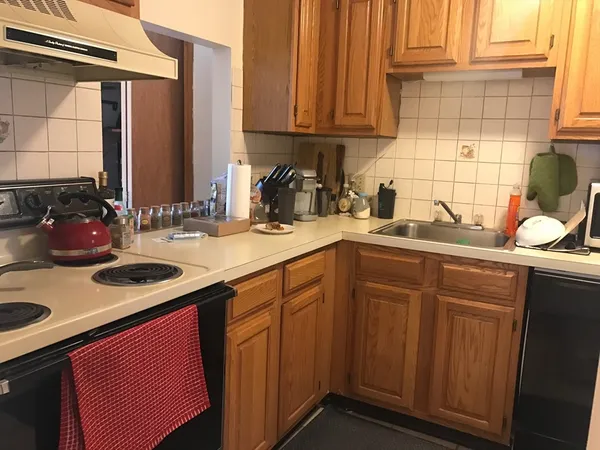 a kitchen with a sink cabinets and window