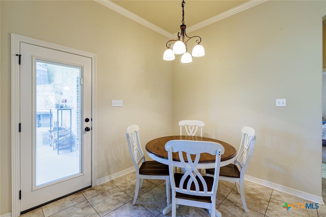 910 Ridgeoak Drive Belton, TX 76513 - Photo 18 of 48 a view of a dining room with furniture and chandelier