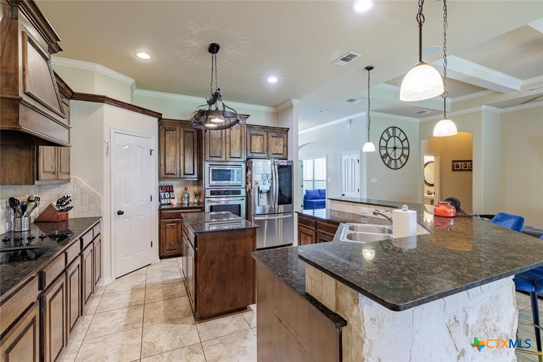 910 Ridgeoak Drive Belton, TX 76513 - Photo 20 of 48 a kitchen with sink cabinets a stove and chairs