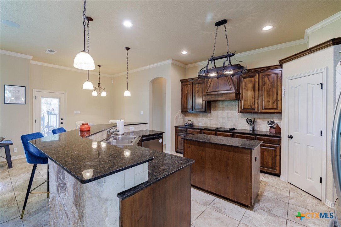910 Ridgeoak Drive Belton, TX 76513 - Photo 22 of 48 a kitchen with stainless steel appliances granite countertop stove a refrigerator a kitchen island a sink and a microwave