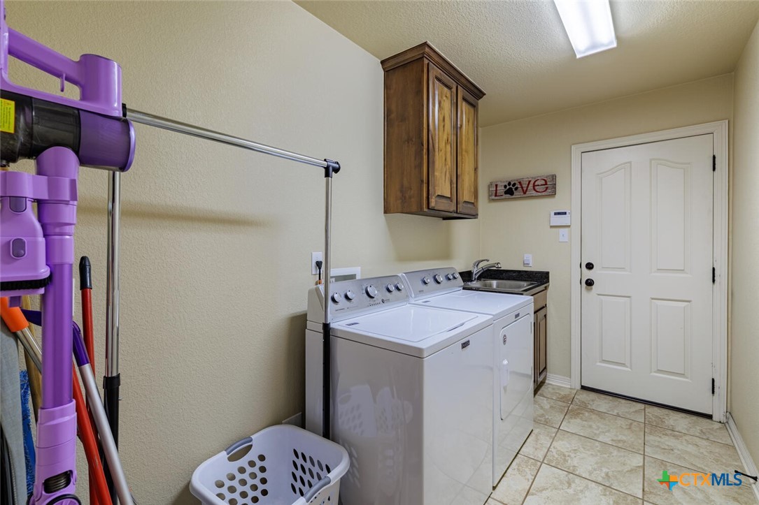 910 Ridgeoak Drive Belton, TX 76513 - Photo 23 of 48 a utility room with cabinets washer and dryer
