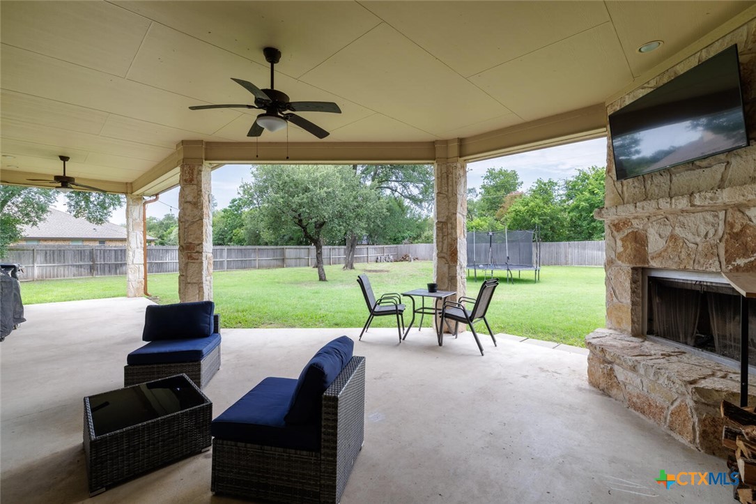 910 Ridgeoak Drive Belton, TX 76513 - Photo 31 of 48 a view of a patio with couches chairs and a floor to ceiling window with garden view