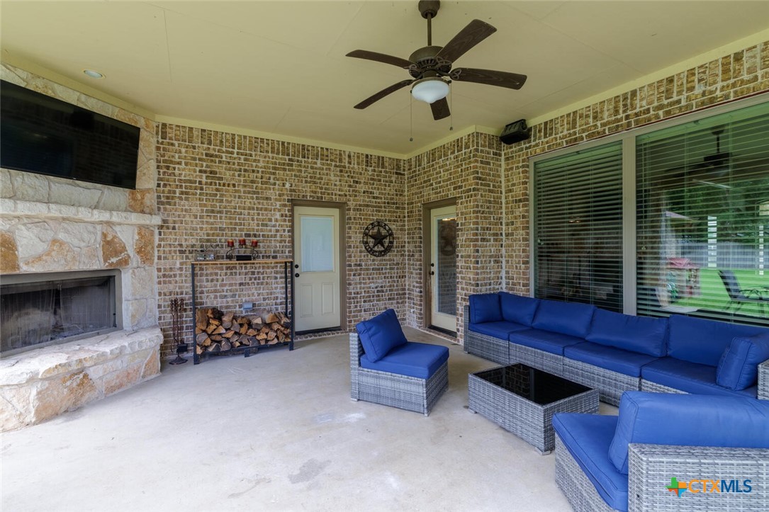 910 Ridgeoak Drive Belton, TX 76513 - Photo 33 of 48 a living room with furniture a flat screen tv and a fireplace
