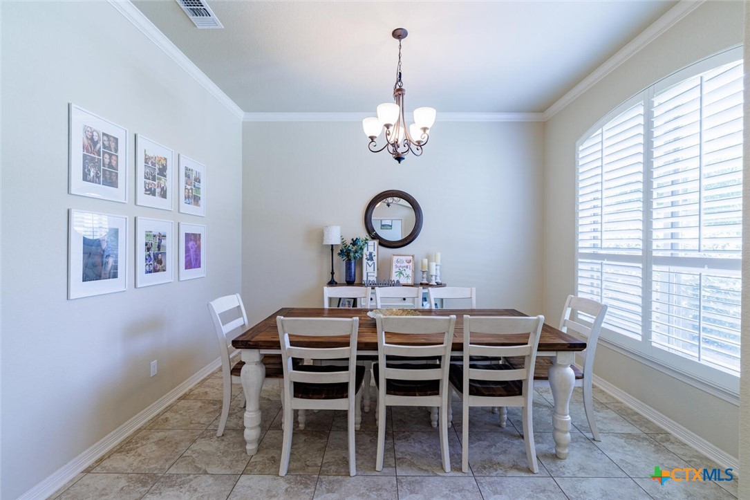 910 Ridgeoak Drive Belton, TX 76513 - Photo 4 of 48 a view of a dining room with furniture a chandelier and a window
