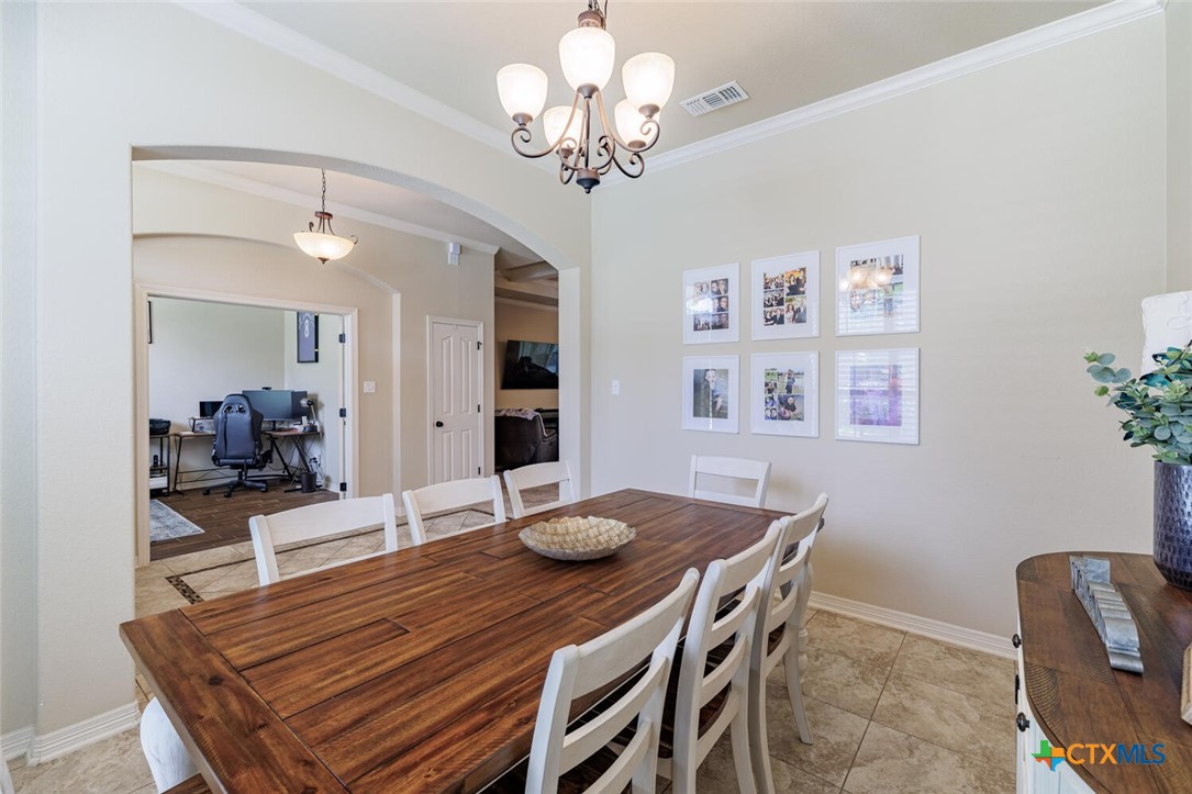 910 Ridgeoak Drive Belton, TX 76513 - Photo 5 of 48 a view of a dining room with furniture and chandelier