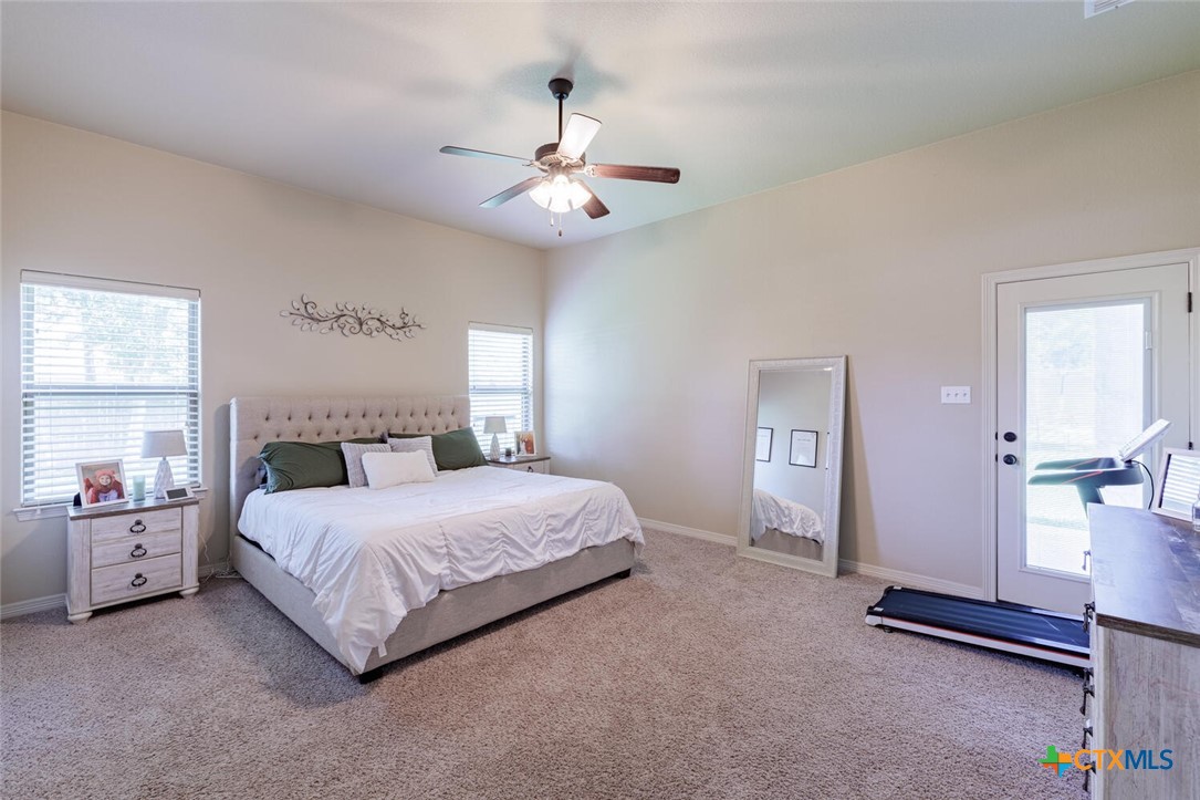 910 Ridgeoak Drive Belton, TX 76513 - Photo 6 of 48 a spacious bedroom with a bed and a chandelier