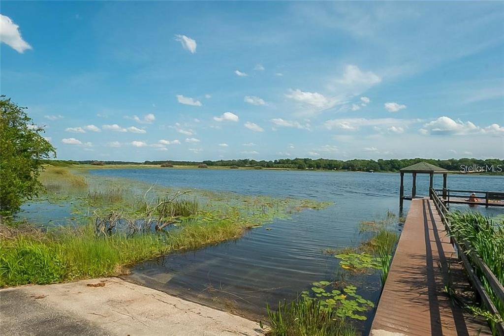 6 Eagle Run Groveland, FL 34736 - Photo 15 of 18 a view of a lake with a floor to ceiling window