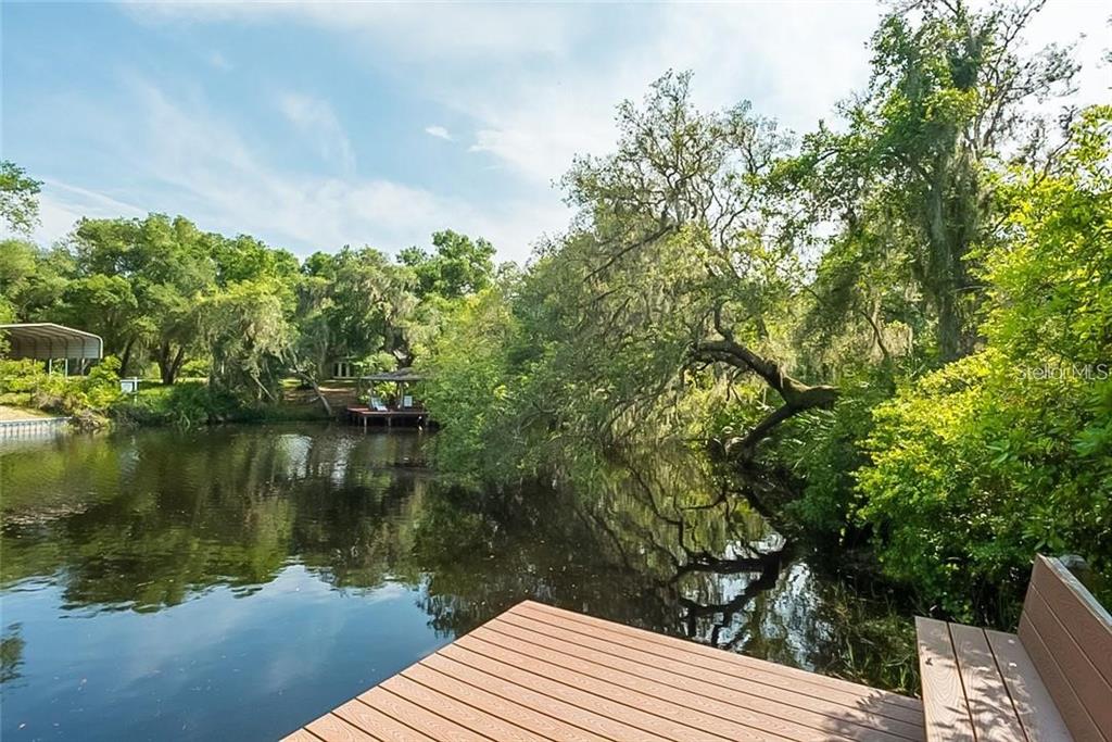 6 Eagle Run Groveland, FL 34736 - Photo 17 of 18 a wooden pier with boats in a lake