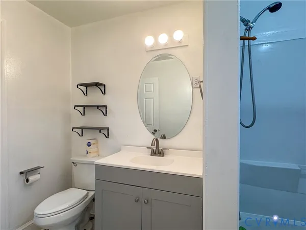 a bathroom with a sink a toilet and a mirror