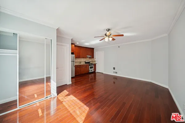 a living room with hardwood floor and a ceiling fan