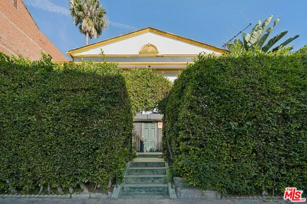 a view of a house with a tree