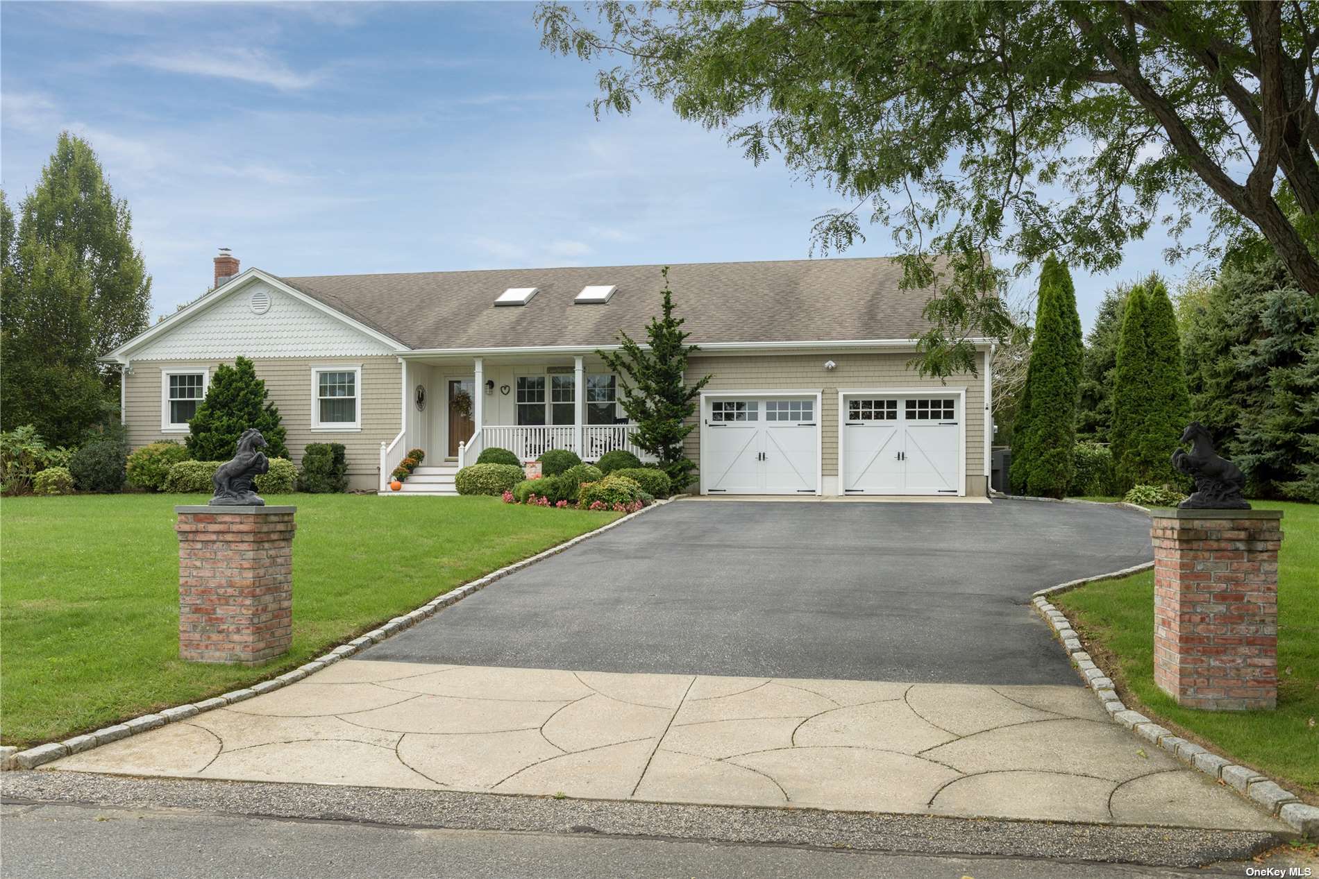a view of a house with a yard and potted plants