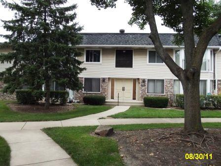 2699 Hobson Road, Unit 7 Woodridge, IL 60517 - Photo 1 of 1 a front view of a house with a yard and garage