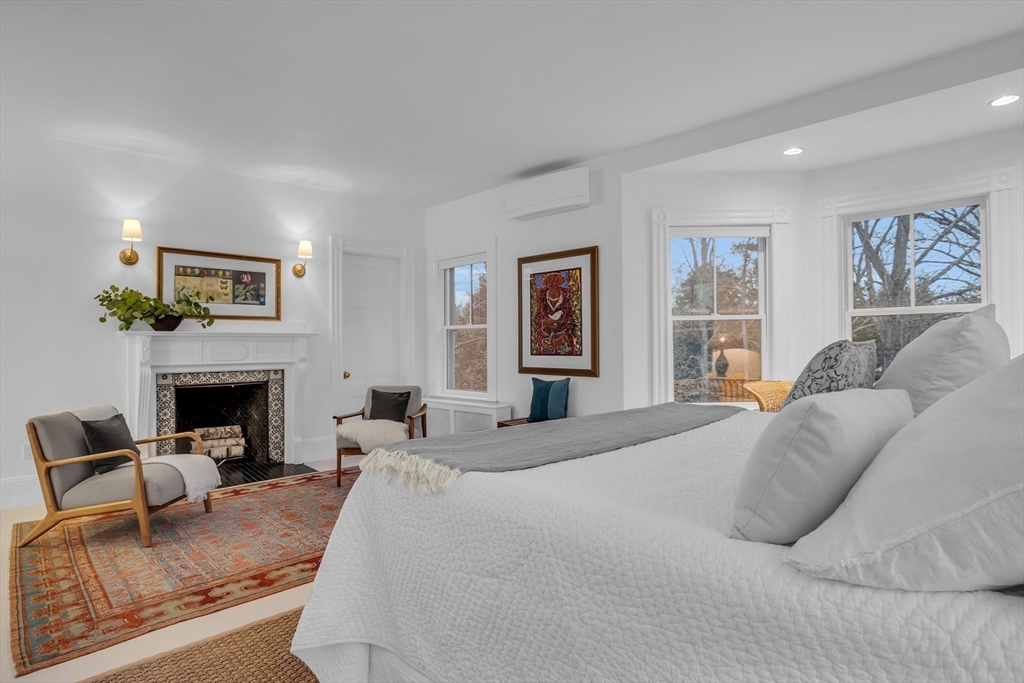 93 Coolidge Road Concord, MA 01742 - Photo 24 of 42 a bedroom with a large bed and a couch