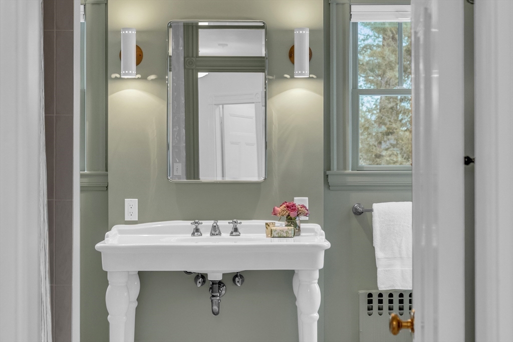 93 Coolidge Road Concord, MA 01742 - Photo 30 of 42 a bathroom with a sink and a mirror