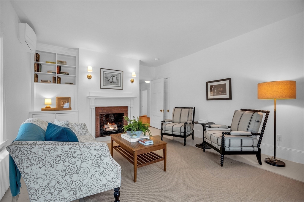 93 Coolidge Road Concord, MA 01742 - Photo 32 of 42 a living room with furniture and a fireplace