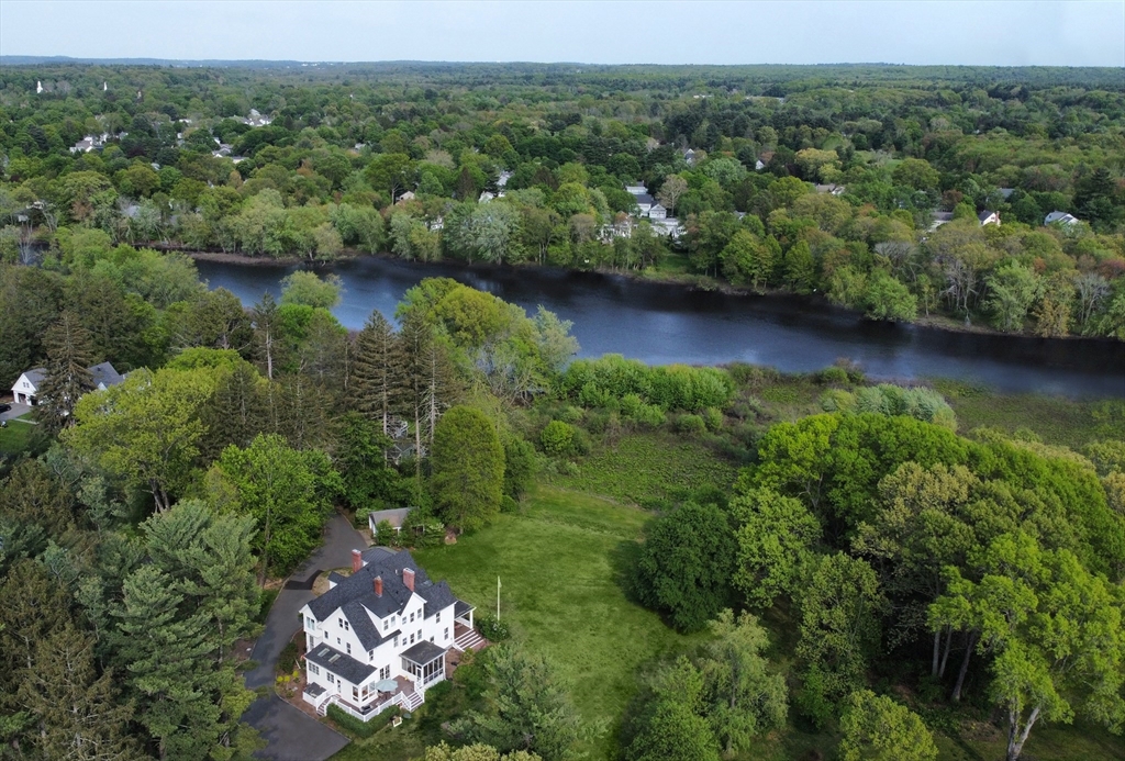 93 Coolidge Road Concord, MA 01742 - Photo 41 of 42 an aerial view of green landscape with trees houses and lake view