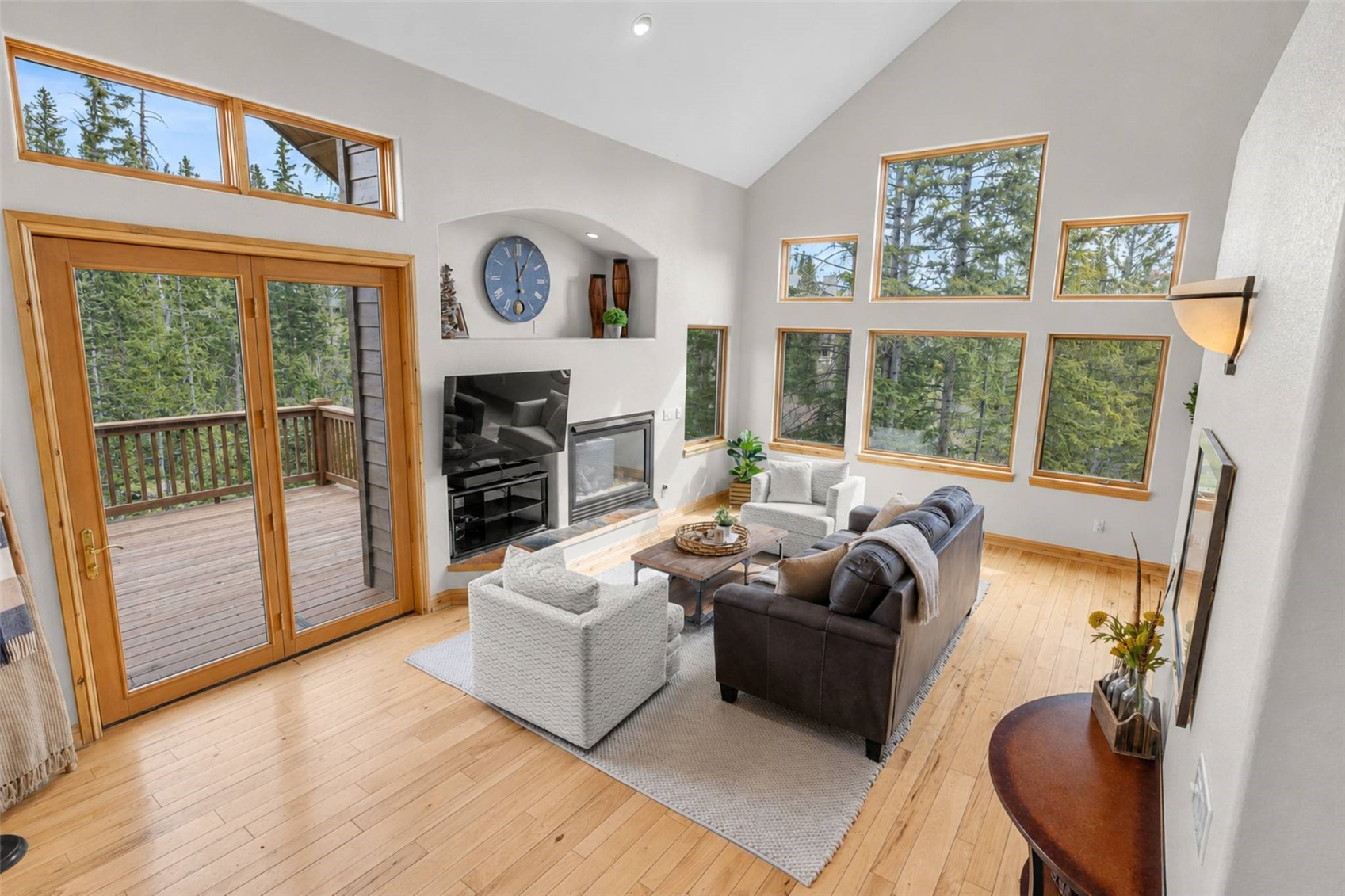 91795 Ryan Gulch Road Silverthorne, CO 80498 - Photo 16 of 50 a living room with furniture a fireplace and a large window