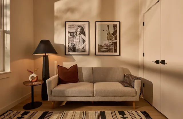 a living room with furniture and a lamp