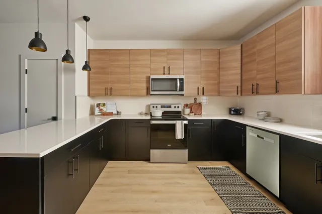 a kitchen with stainless steel appliances a stove sink and cabinets