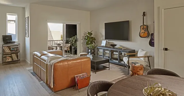 a bedroom with furniture and a flat screen tv